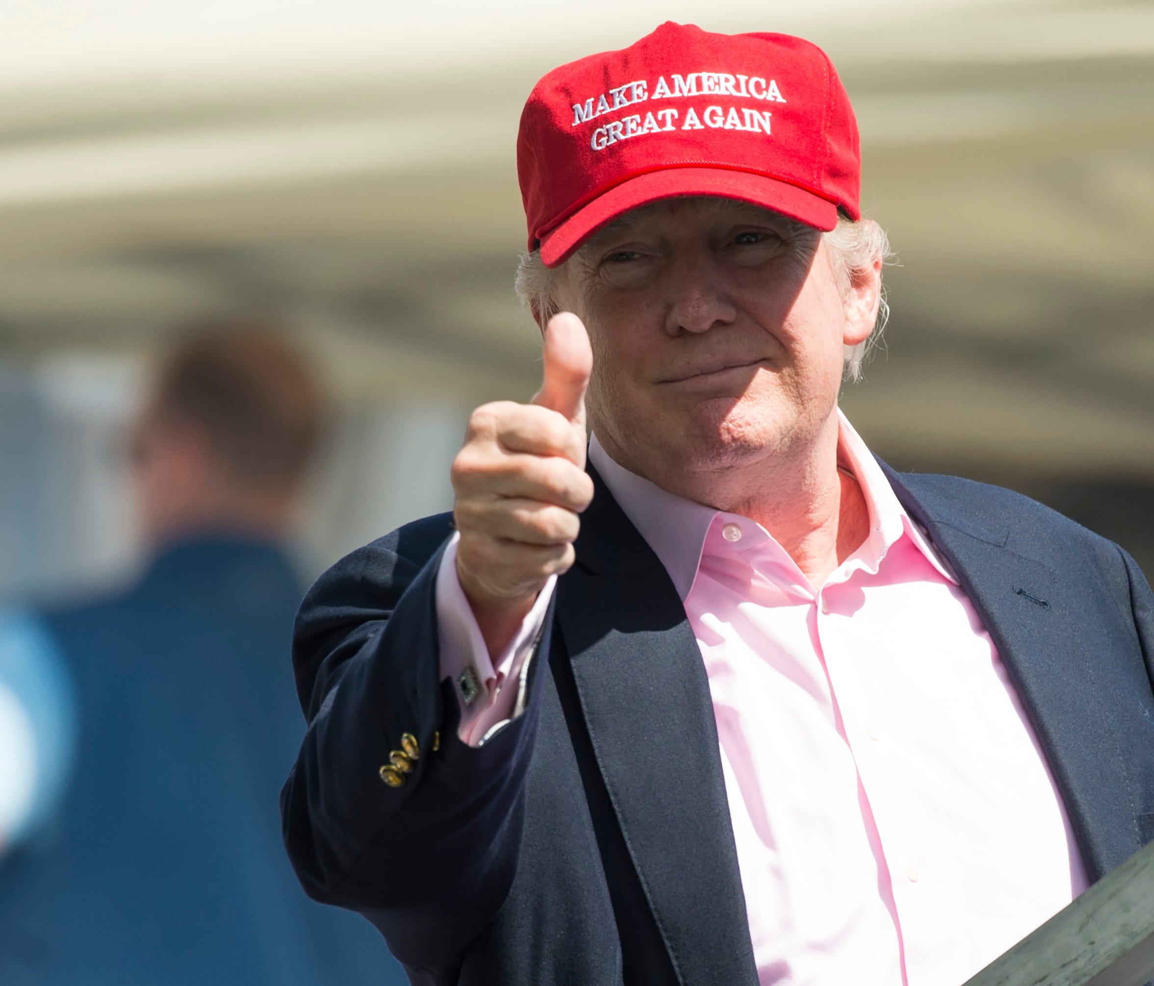President Donald Trump gives a thumbs-up well wishers as he arrives at the 72nd US Women's Open Golf Championship at Trump National Golf Course in Bedminster, New Jersey, July 16, 2017.