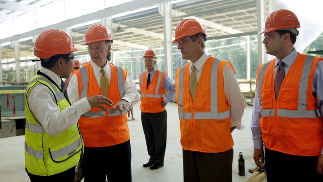 
Gov. Robert Bentley talks with Golden Dragon USA President Roger Zhang, left, during an August 29, 2013, tour of the Pine Hill plant while it was under construction. Workers at the plant narrowly voted to unionize on Nov. 7, despite a letter from the governor urging a no vote. Objections have been filed to the election.
