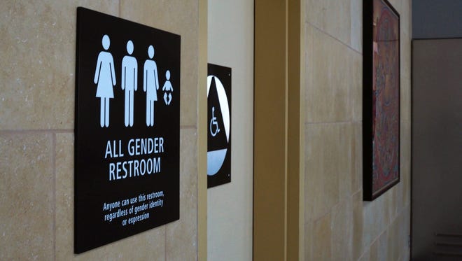 An April 16, 2016, file photo shows an "All Gender" bathroom sign at the San Diego International Airport.