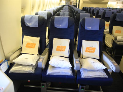 Gift bags rest on the chairs of the last United Airlines
