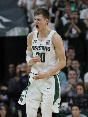 Matt McQuaid reacts after hitting a 3-pointer against Purdue during the second half Saturday.