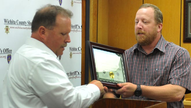 Wichita County Deputy Patrick Bradford (right) accepts a certificate of merit Wednesday afternoon from sheriff David Duke during the Sheriffs Office Quarterly Award Ceremony. Bradford received a Leads Online tip of possible stolen firearms out of Wichita County. Bradford pursued the case by communicating with various law enforcement agencies as well as pawn shops in Mississippi until the firearms were found and returned to their rightful owner, per a press release.