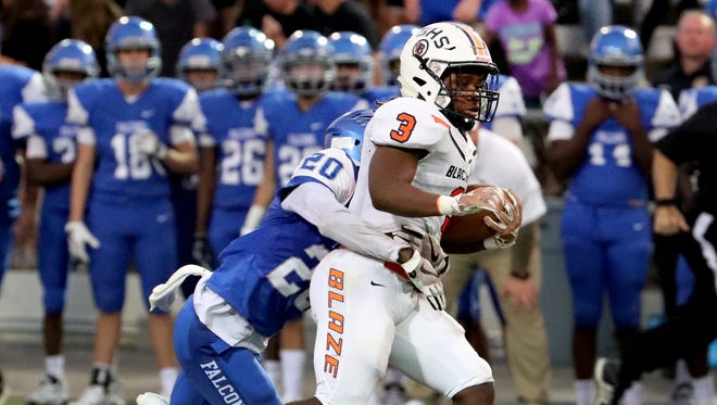 Blackman's Tamicus Napier (3) runs the ball as Florence's Nick Waller (20) tries to bring him down on Friday, Aug. 24, 2018 at Braly Municipal Stadium, in Florence, Alabama.