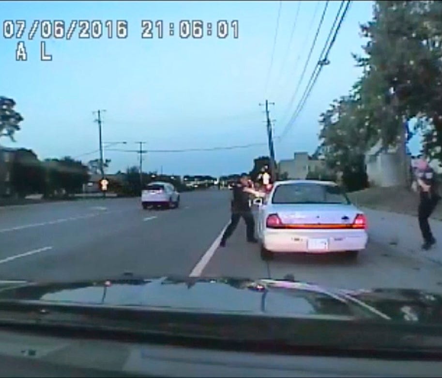 In this image made from July 6, 2016, video captured by a camera in the squad car of St. Anthony Police officer Jeronimo Yanez, the Minnesota police officer shoots at Philando Castile in the vehicle during a traffic stop in Falcon Heights, Minn. Yane