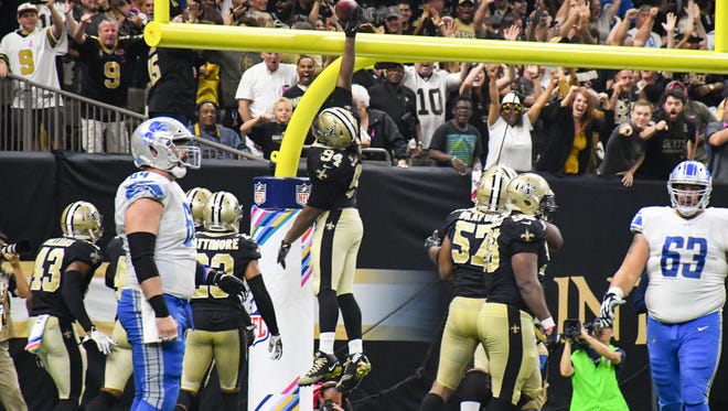 Defensive end Cameron Jordan dunks the ball over the goal as the New Orleans Saints take on the Detroit Lions in the Mercedes-Benz Superdome. Sunday, Oct. 15, 2017.