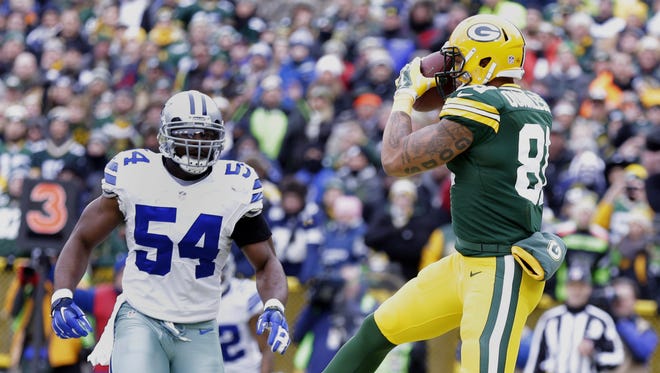 Green Bay Packers tight end Andrew Quarless catches a touchdown pass in the first quarter behind Dallas' Bruce Carter during the NFC divisional playoff Sunday, January 11, 2015, at Lambeau Field.