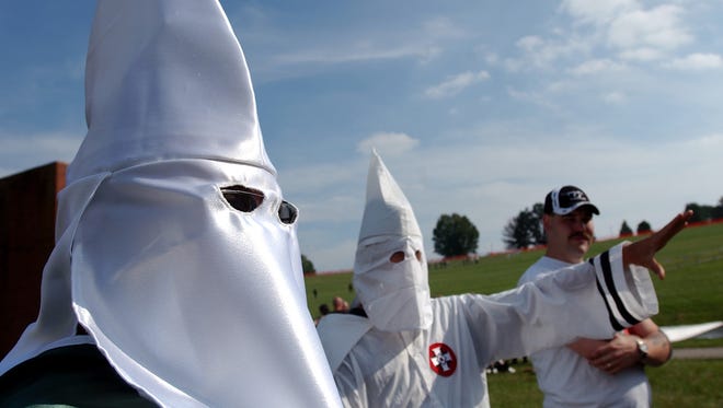 Members of the Ku Klux Klan participate in a rally in 2004.