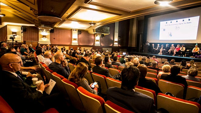 Community members look on as Downtown Inc Small Business Liaison Natalie Williams gives an update on new restaurants in the area, last month during the Spring Downtown Update meeting at Capitol Theatre. Amanda J. Cain photo