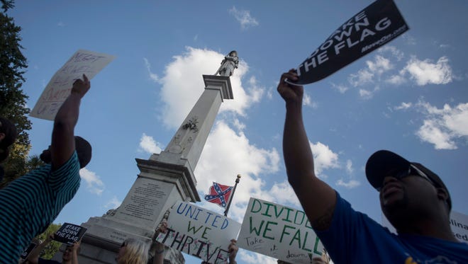 Protesters gather at the South Carolina state Capitol Tuesday to protest the presence of a Confederate battle flag flying on the grounds.