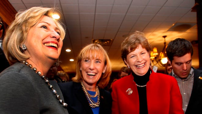 Hillary Rodham Clinton, left, talks to voters with U.S. Sen. Jeanne Shaheen, D-N.H., right, and Gov. Maggie Hassan, D-N.H., at the Puritan Backroom Restaurant, Sunday, Nov. 2, 2014 in Manchester, N.H.
