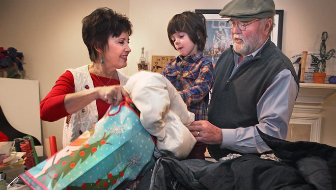 Ron and Sally Pearson, pictured here with their grandson, Steele Trost, have been adopting families through United Christmas Service for more than 30 years.