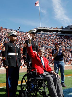 In this Saturday, Nov. 5, 2016 photo, Jack Simms, a journalist and author who helped build Auburn University's journalism department, is honored as a part of Auburn University's Military Appreciation Day in Auburn, Ala., when Auburn hosted Vanderbilt in a NCAA college football game. Sims, beloved by students and colleagues for his quick wit and enthusiasm, died Tuesday, Nov. 8, 2016. He was 89.