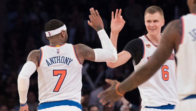 New York Knicks forward Carmelo Anthony (7) and forward Kristaps Porzingis (6) celebrate after Anthony scored a 3-point goal during the second half of an NBA basketball game against the Dallas Mavericks, Monday, Nov. 14, 2016, at Madison Square Garden in New York. The Knicks won 93-77.