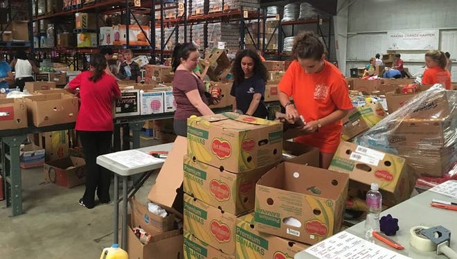Volunteers sorted food and non-food essentials in the warehouse. More help is need. Visit www.stophunger.org  to sign up.