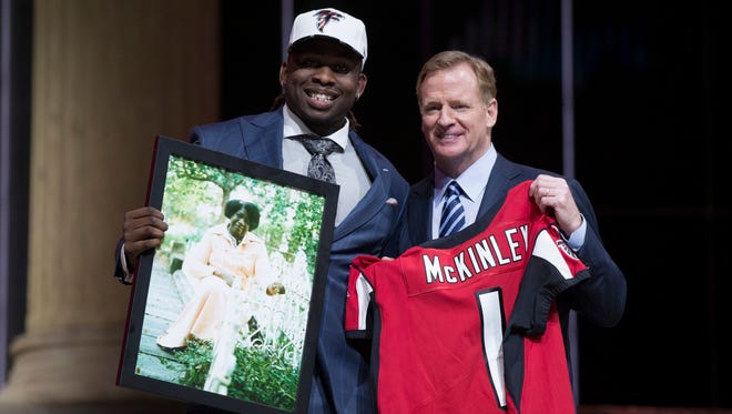 Takkarist McKinley (UCLA) poses with NFL commissioner Roger Goodell as he holds a photo of his grandmother as he is selected as the number 26 overall pick to the Atlanta Falcons in the first round the 2017 NFL Draft at the Philadelphia Museum of Art.