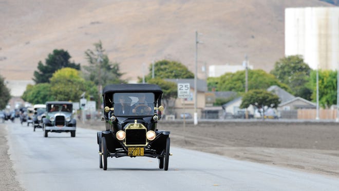 Jim Skillikorn drives his 1915 Ford Model T at the head of a procession of vintage cars out of Spreckels, CA. He is a member of the Horseless Carriage Club of America.