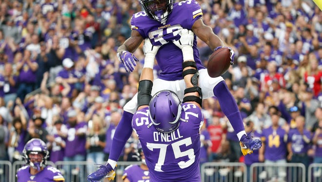 Minnesota Vikings running back Dalvin Cook (33) celebrates with teammate Brian O'Neill after a 19-yard touchdown run during the first half of an NFL football game against the Atlanta Falcons, Sunday, Sept. 8, 2019, in Minneapolis. (AP Photo/Bruce Kluckhohn)