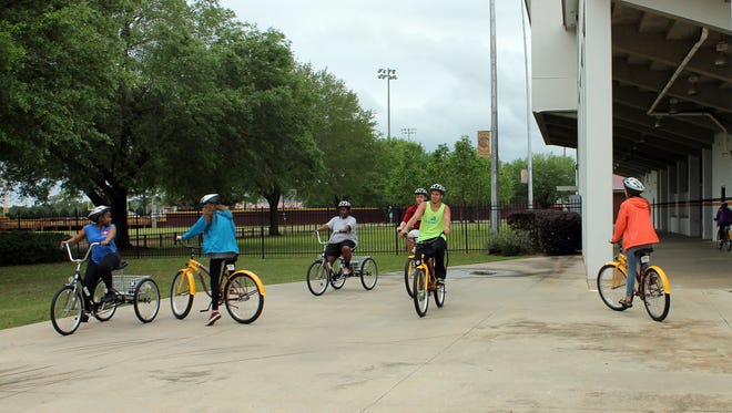 Students try out the bicycles and tricycles during the Wildcat Wellness Bike Kickoff at Dobie Holden Stadium.