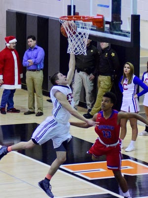 Ryle's Logan Turner finishes with a layup as Conner's Michael Scott can only watch.