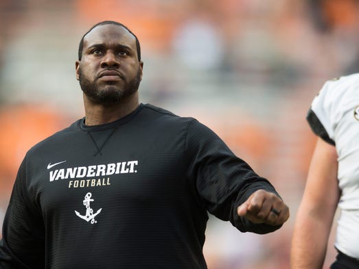 A Vanderbilt assistant watches players before a game