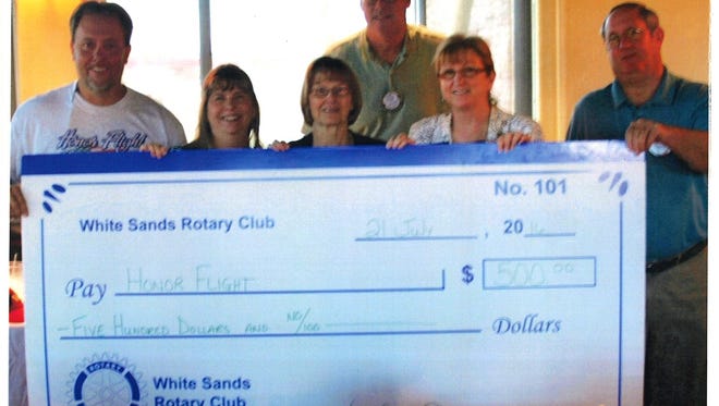 A donation of $500 was made to the Honor Flight of Southern New Mexico by the Rotary Club of White Sands-Alamogordo following a presentation at the club's weekly meeting by Dale Lindley, pictured at left above. Also pictured are club president Sue Strother, with board members Jan Jeter, Steve Boyle, Robyn Luevano and Marc Joyner. In eight years the Honor Flight of Southern New Mexico has taken nearly 300 veterans, including 30 from Otero County to Washington, D.C. to visit their war memorials, all expenses paid. This is made possible by private donations, fundraisers and corporate donations.