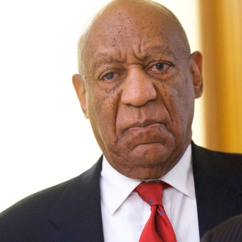 Actor and comedian Bill Cosby reacts while being...