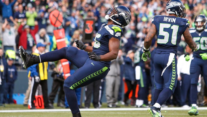 Seattle Seahawks defensive end Cliff Avril (56) celebrates his sack against the Arizona Cardinals during the second quarter at CenturyLink Field.