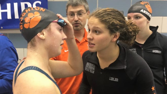 Brighton's Kellie House (left) is greeted by teammate Julianne Libler after finishing eighth in the 500-yard freestyle at the state Division 1 meet Saturday at Oakland University.