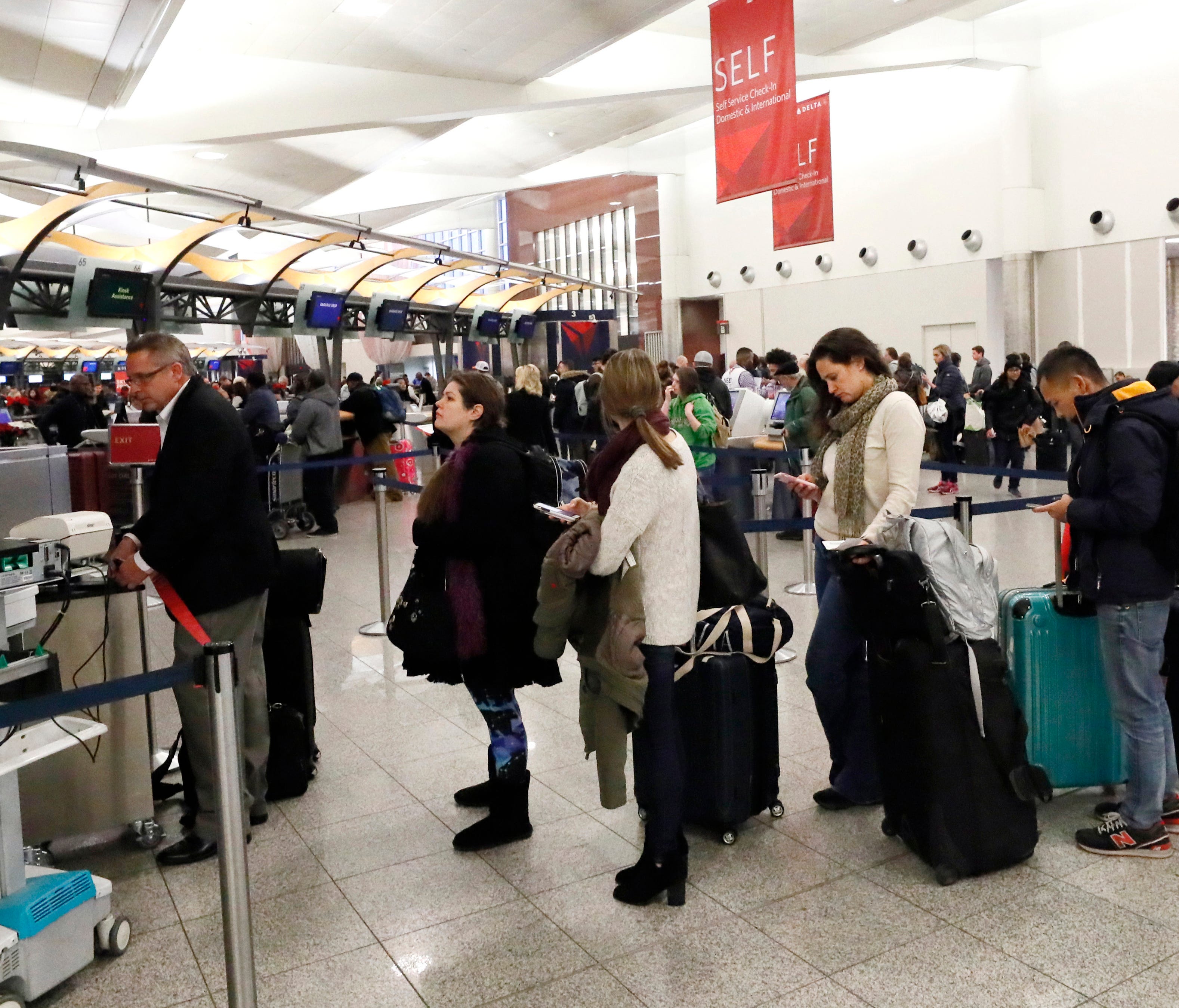 Travelers line up for assistance at Atlanta Hartsfield-Jackson International Airport on Dec. 8, 2017, as hundreds of flights were canceled due to a snowstorm.