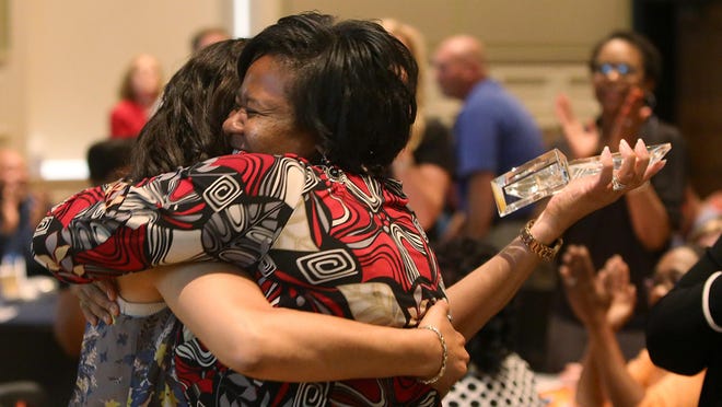 April Thomas, right, hugs Sabrina Anderson, executive director of the Boys & Girls Club of Jackson, after Anderson addressed the crowd upon receiving the David Hallock Memorial Award during United Way of West Tennessee’s Community Celebration Breakfast in this April 2016 file photo.