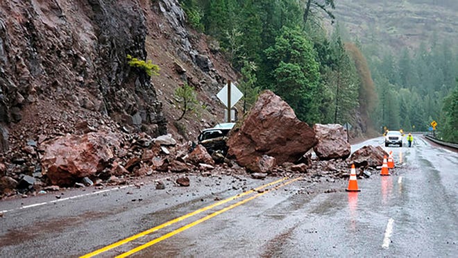 Two enormous fell onto Highway 62 on Tuesday, almost crushing a car outside Prospect, Ore.