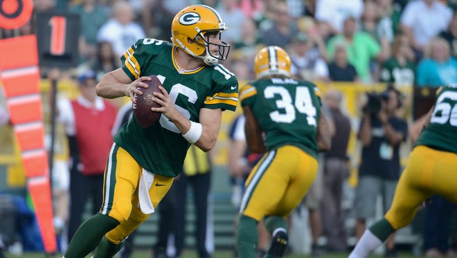 Green Bay Packers quarterback Scott Tolzien (16) rolls out in the first quarter of a preseason game between the Green Bay Packers and the New Orleans Saints in September 2015.