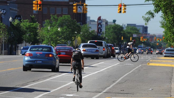 Bicycle riders travel along Main Street at Austin Avenue in downtown Royal Oak, where city development plans have withstood a legal challenge before the Michigan Supreme Court.