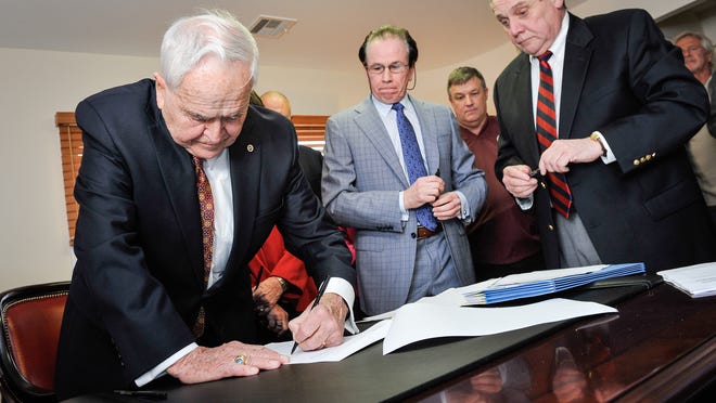 
Toms River Mayor Thomas F. Kelaher (left), signs the agreement as John R. McDonough (2nd from left), a Broker at Ocean Beach Sales and Rental and Kenneth B. Fitzsimmons, Toms River’s Attorney (right) look on. The agreement, signed April 11, grants easements for beach replenishment and dunes. 
