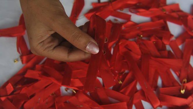 The red ribbon remains as a symbol of awareness and support for those affected by HIV/AIDS.