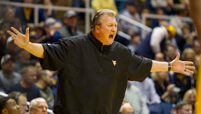 West Virginia Mountaineers head coach Bob Huggins argues with a referee during the first half at the WVU Coliseum.