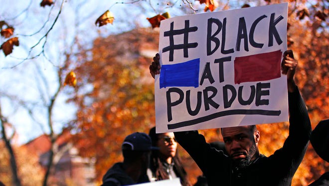 James Haynes, a Purdue University graduate student , holds a sign at a rally Nov. 13, 2015 as part of a protest against racial bias and exclusion. Haynes recently said he is skeptical that the university's  new research initiatives to improve diversity and climate on campus will be effective.