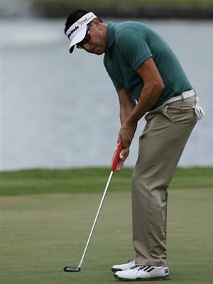 Robert Allenby of Australia putts on the third green during the second round of the Sony Open golf tournament, Friday, Jan. 16. 2015, in Honolulu. Allenby says he was robbed, beaten and dumped in a park Saturday Jan. 17, 2015 after missing the cut in the Sony Open, leaving him with cuts and a deep scrape on his forehead. (AP Photo/Hugh Gentry)