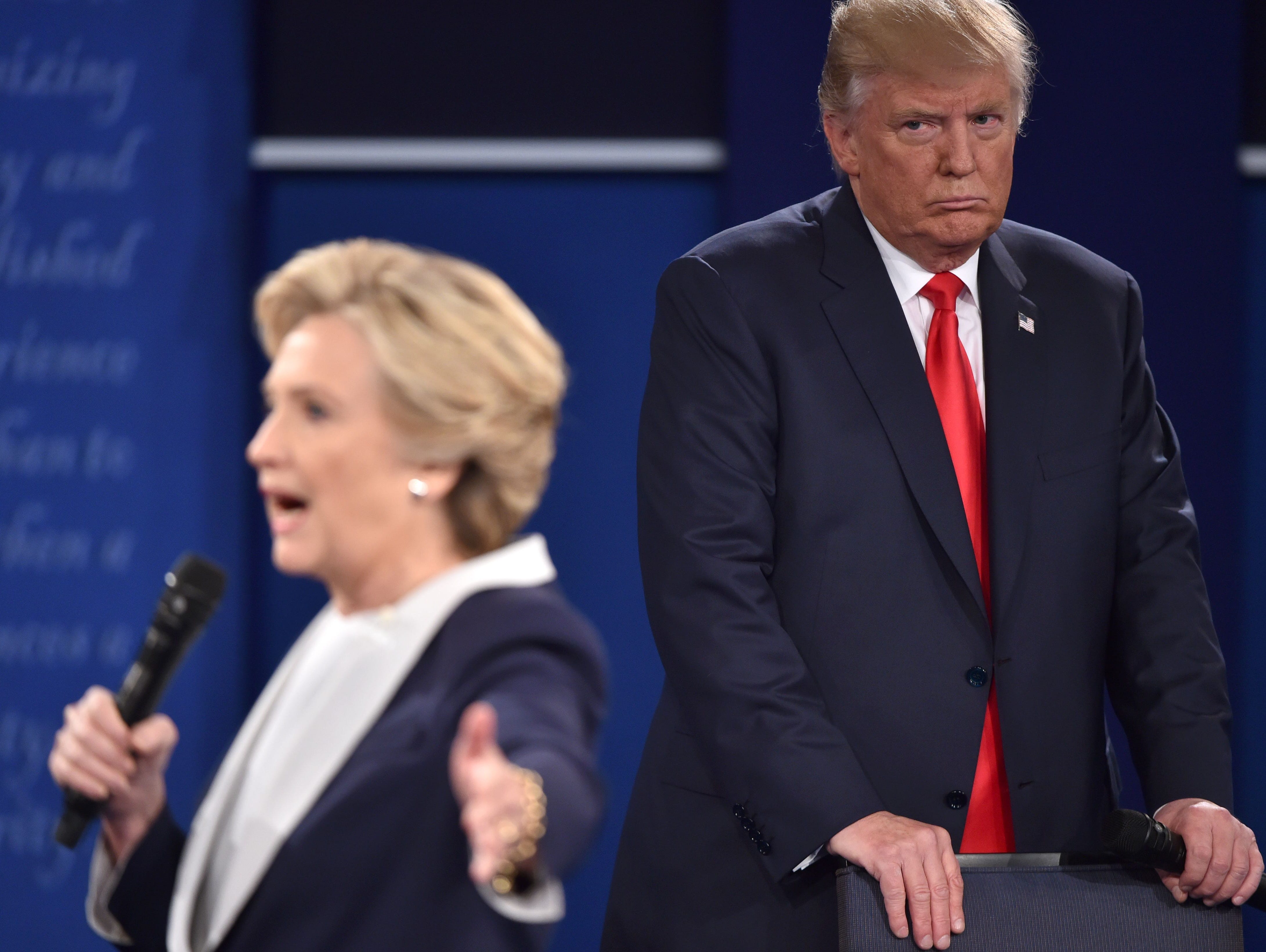 Republican presidential candidate Donald Trump as he listens to Democratic presidential candidate Hillary Clinton during the second presidential debate at Washington University in St. Louis.