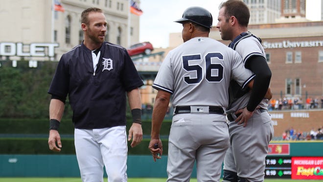 Andrew Romine, left, of the Detroit Tigers talks to his brother Austin Romine, right, of the New York Yankees and first base coach first base coach Tony Pena during a bench clearing fight in the seventh inning at Comerica Park on August 24, 2017 in Detroit.