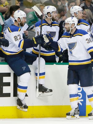 St. Louis Blues right wing Troy Brouwer (36) celebrates scoring a goal with Alex Pietrangelo (27), Carl Gunnarsson (4) and other teammates on the bench during the first period of Game 2 of the NHL hockey Stanley Cup Western Conference semifinals against the Dallas Stars, Sunday, May 1, 2016, in Dallas.