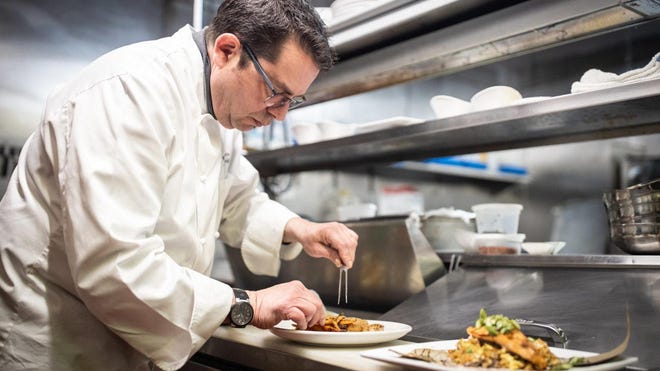 Chef Walter Leffler plates an entree at the Revolution Taproom and Grill in Rochester.