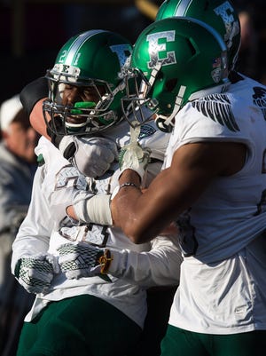 Eastern Michigan receiver Antoine Porter is greeted by teammates after scoring a touchdown against Western Michigan on Oct. 22, 2016.