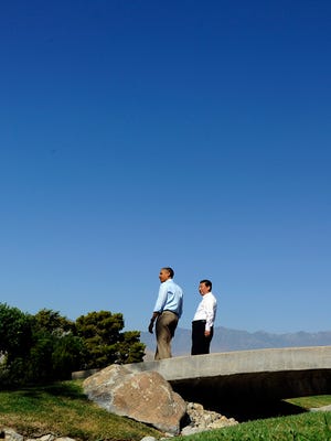 U.S. President Barack Obama, left, and Chinese President Xi Jinping chat as they take a walk at the Annenberg Retreat at Sunnylands in Rancho Mirage, California, on June 8, 2013.