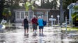 Larry Donnerstag, 87, center, is helped back to his
