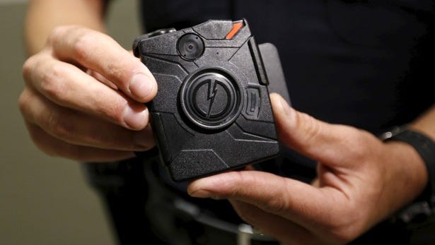 LAPD information technology bureau officer Jim Stover demonstrates the use of the body camera during a media event displaying the new body cameras to be used by the Los Angeles Police Department in Los Angeles, California August 31, 2015.