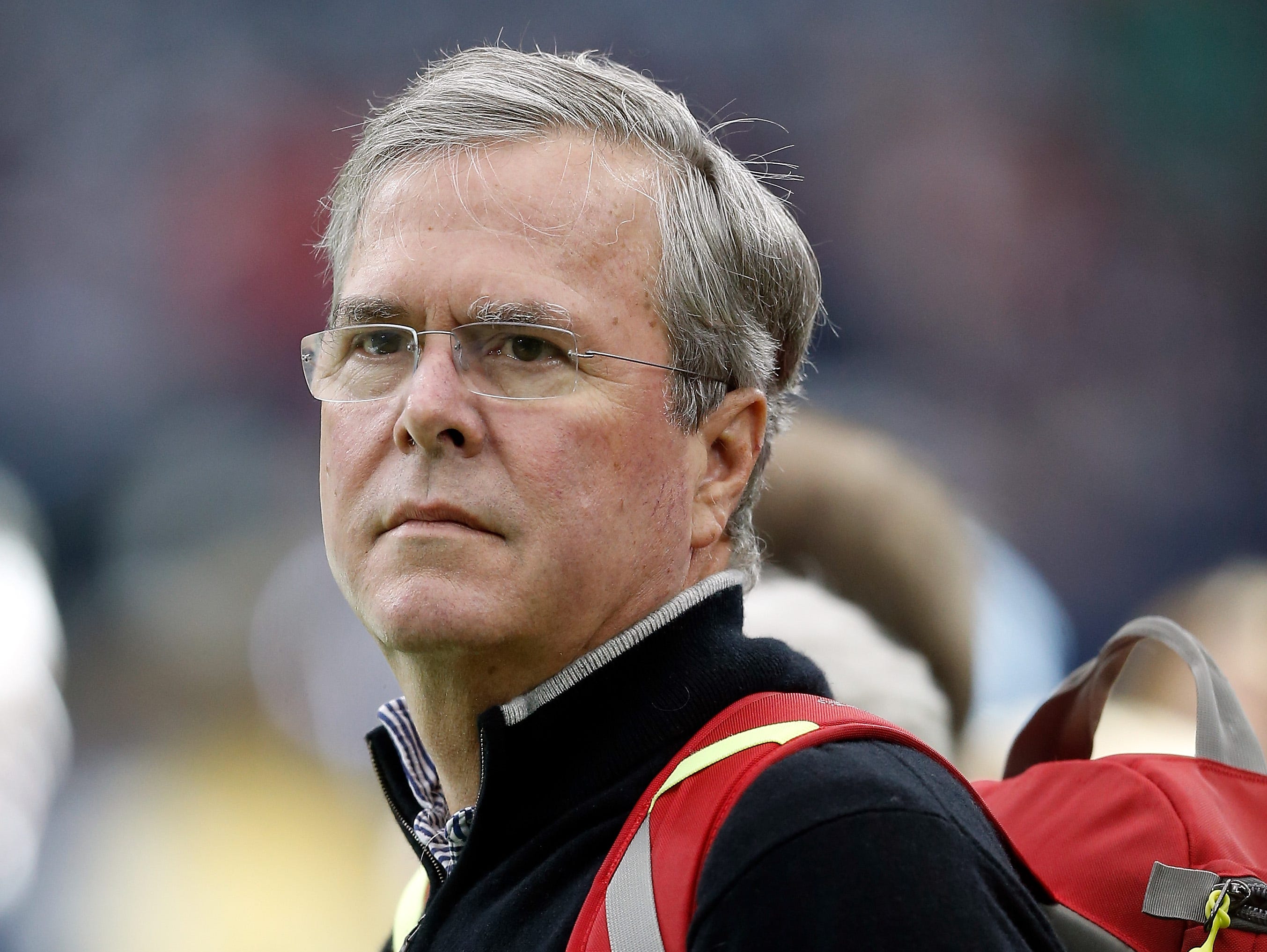 Jeb Bush watches the pregame warmup of the Houston Texans before their game against the Oakland Raiders in the AFC Wild Card game at NRG Stadium on Jan. 7, 2017 in Houston, Texas.