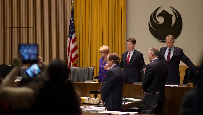 Councilwomen Thelda Williams, Mayor Greg Stanton and Councilman Jim Waring (L to R) hold hands in the opening prayer of the council meeting in Phoenix Ariz. on Wednesday Feb. 3, 2016.