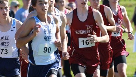 Licking Heights sophomore Dalton Weber (161) runs with Granville's Jack McGonagle (90) and Jonny Lukins during the Granville Invitational at Bryn Du Saturday.