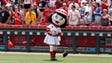 June 8: Reds mascot Rosie Red sweeps with a broom marking